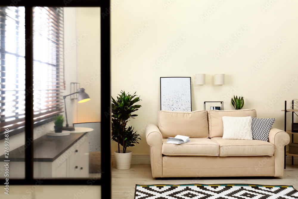 Fototapeta premium Living room interior with sofa, window blinds and stylish decor elements