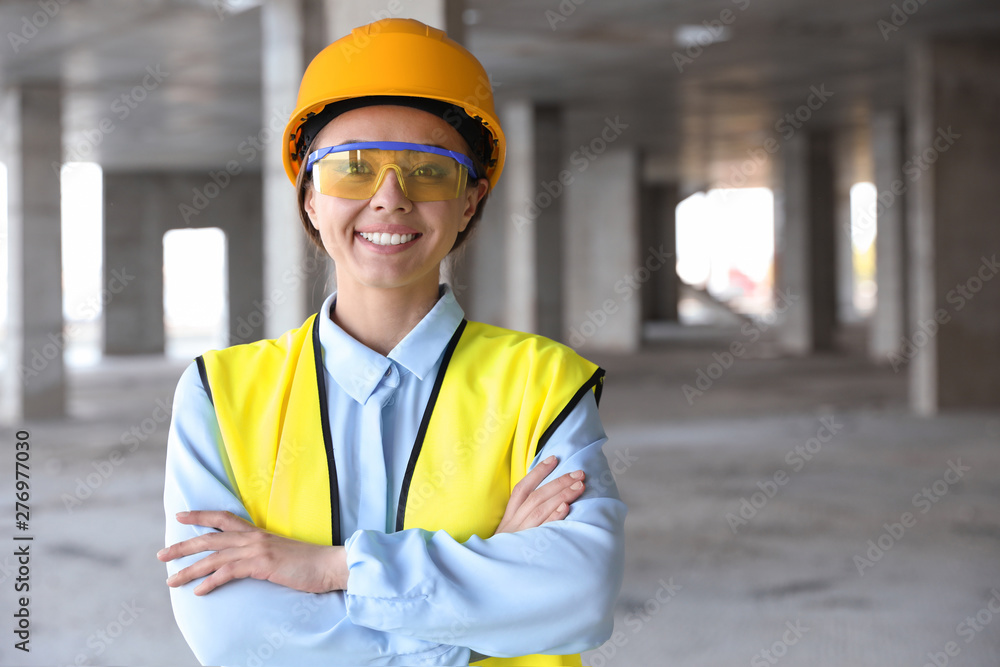 Professional engineer in safety equipment at construction site, space for text Professional engineer in safety equipment at construction site, space for text