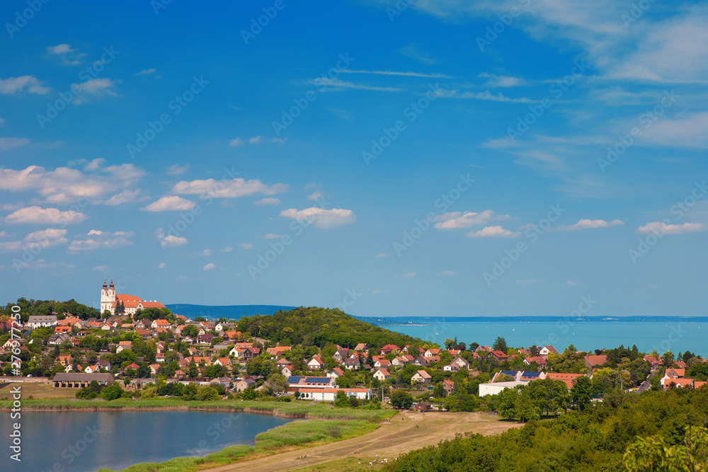 Panoramic view of Tihany village with the famous abbey on the top of the hill and the Lake Balaton in the background and the inner lake on a sunny day in Hungary