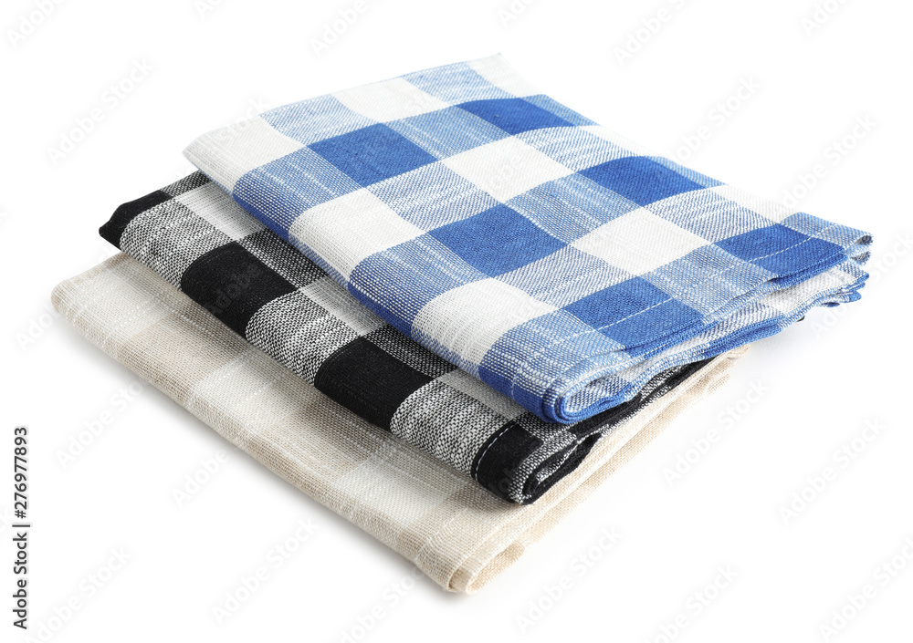 Folded checkered kitchen towels on white background