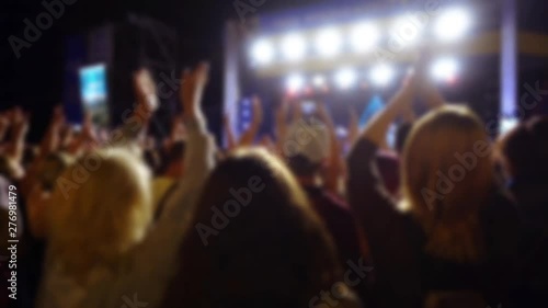 Concert on the stage. Crowd of people and musicians on the scene. Out of focus. photo