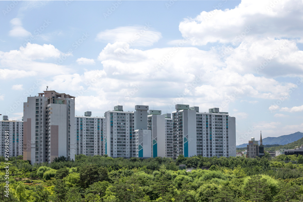 Green grass parks with apartment building.