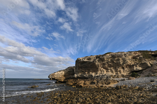 Sandstone guards at the coastline of Arniston photo