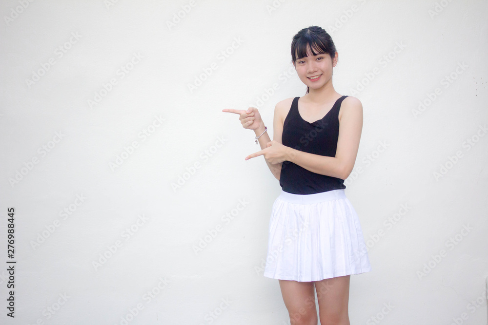 Portrait of thai adult beautiful girl black shirt white skirt pointing Portrait of thai adult beautiful girl black shirt white skirt pointing