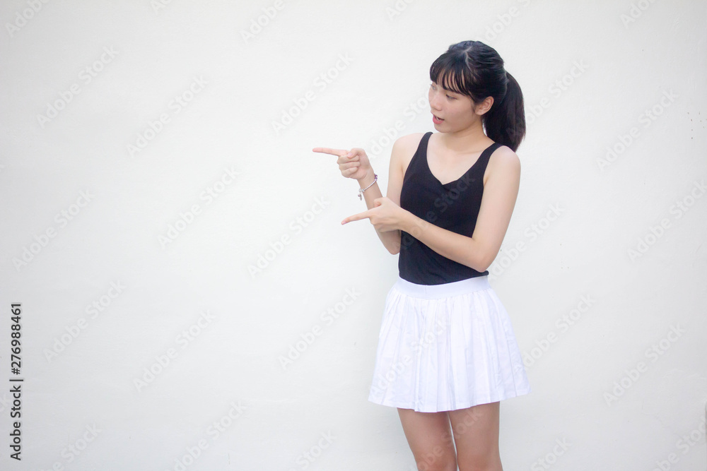 Portrait of thai adult beautiful girl black shirt white skirt pointing Portrait of thai adult beautiful girl black shirt white skirt pointing