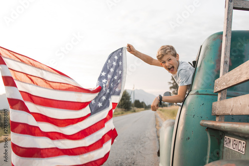 cheering boy waving american flag