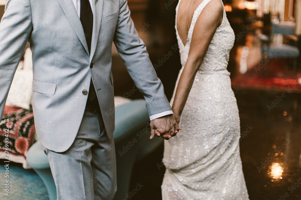 black and white photo of bride and groom holding hands black and white photo of bride and groom holding hands
