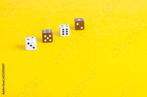 Simple game cubes, dice on bright yellow background. Casino gambling concept