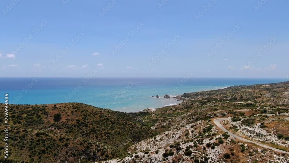 Aerial view of the beautiful green island with hills on the coast sea on sunny day. Drone footage of amazing subtropical isle under blue sky and hot sun in summer. Aerial view of the beautiful green island with hills on the coast sea on sunny day. Drone footage of amazing subtropical isle under blue sky and hot sun in summer.