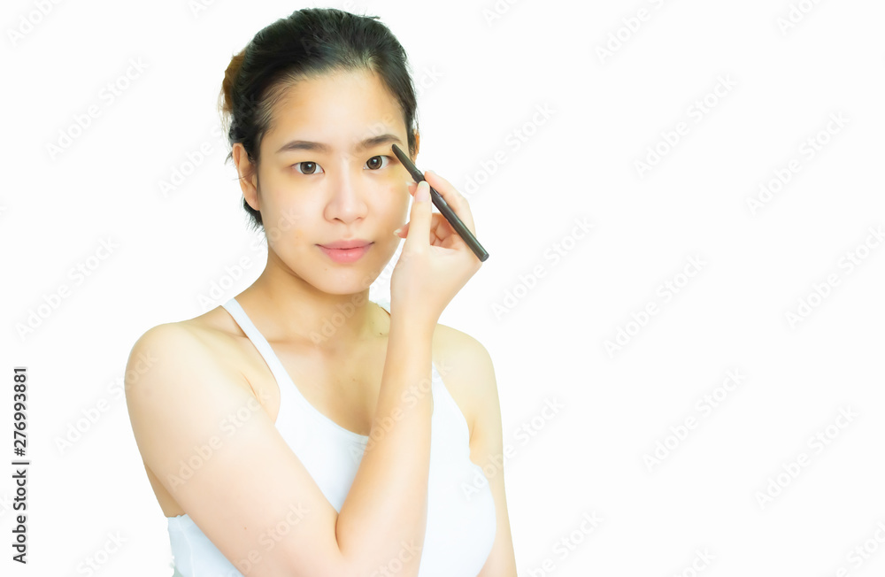 A beautiful asian woman is using eyebrow pencil on white background A beautiful asian woman is using eyebrow pencil on white background