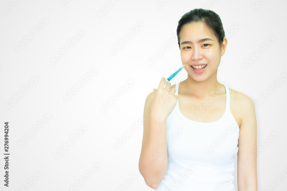 A beautiful asian woman is doing boton treatment on white background A beautiful asian woman is doing boton treatment on white background