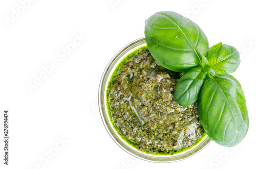 Pesto sauce and fresh green basil leaves. 