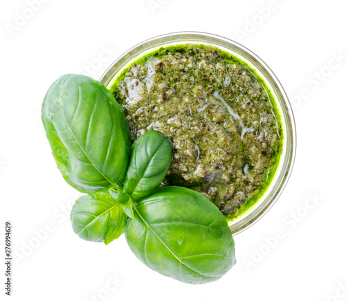 Pesto sauce and fresh green basil leaves. 