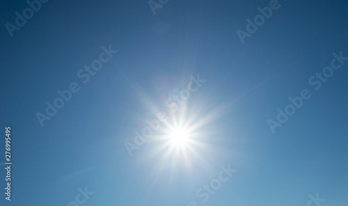 Shining sun blue sky with lens flare