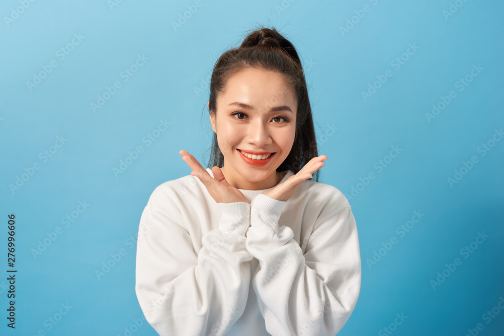 Portrait of joyful carefree adorable adult woman smiling broadly and holding palms near cheeks, being playful and emotive with positive attitude to life Portrait of joyful carefree adorable adult woman smiling broadly and holding palms near cheeks, being playful and emotive with positive attitude to life