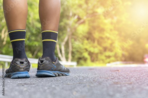 Man runner feet on road in Park workout wellness soft focus and focus close up on shoe