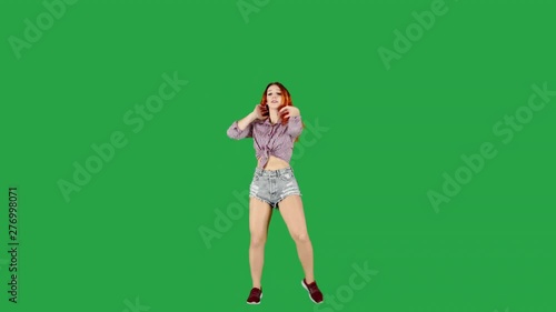 Countrygirl Dancing in Ripped Shorts and Checkered Shirt on Green Screen photo