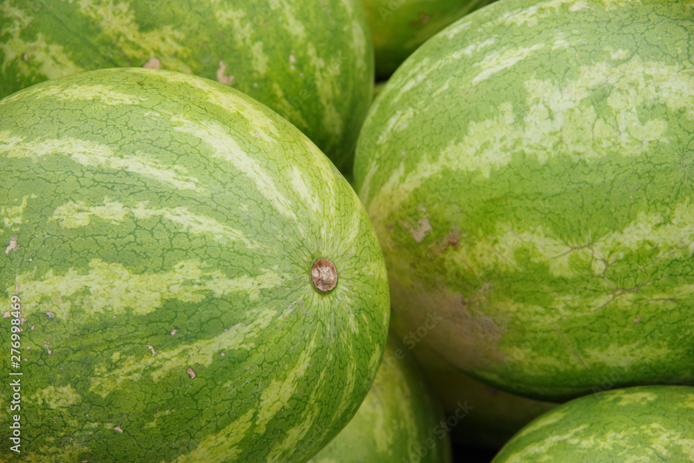 Close up full frame view of watermelons displayed for sale at a market stand Close up full frame view of watermelons displayed for sale at a market stand