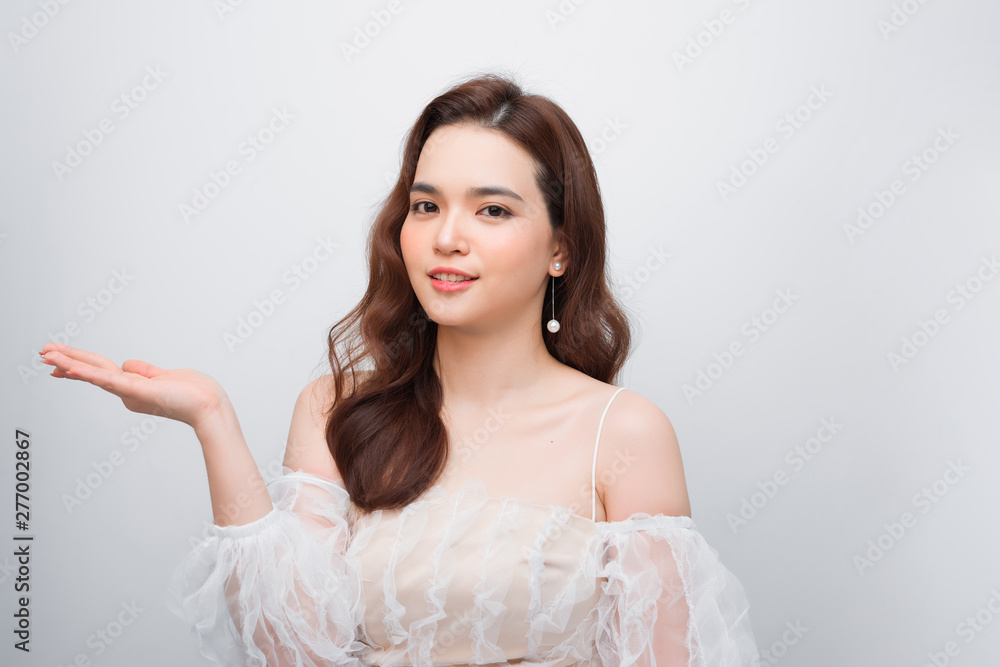 Body skincare care beauty Asian woman showing product on side with open hand Body skincare care beauty Asian woman showing product on side with open hand