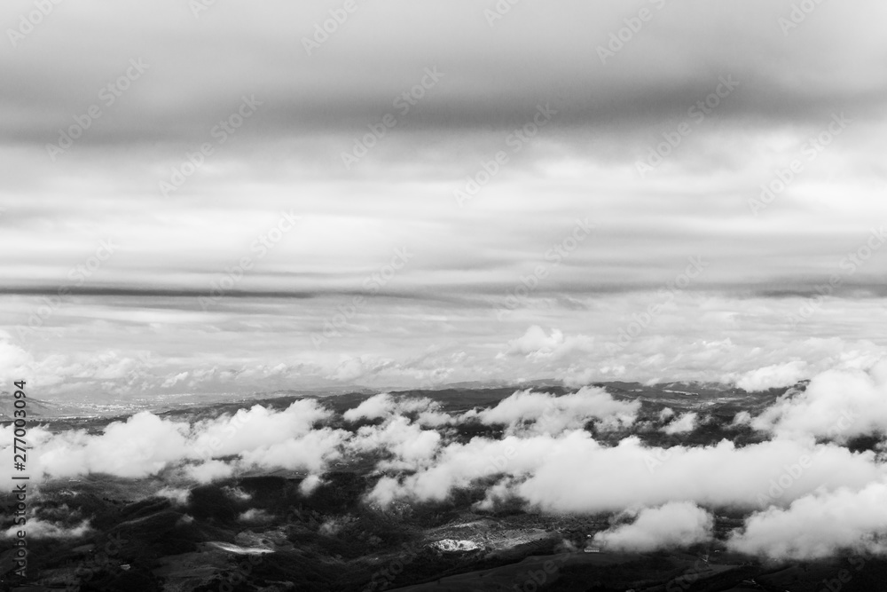 View from above of Umbria valley, with cloudscape both above and below