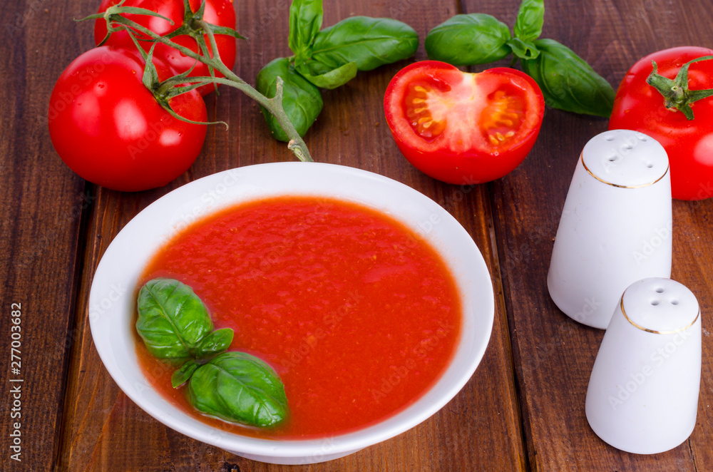 Cold tomato soup on wooden surface. Photo Cold tomato soup on wooden surface. Photo