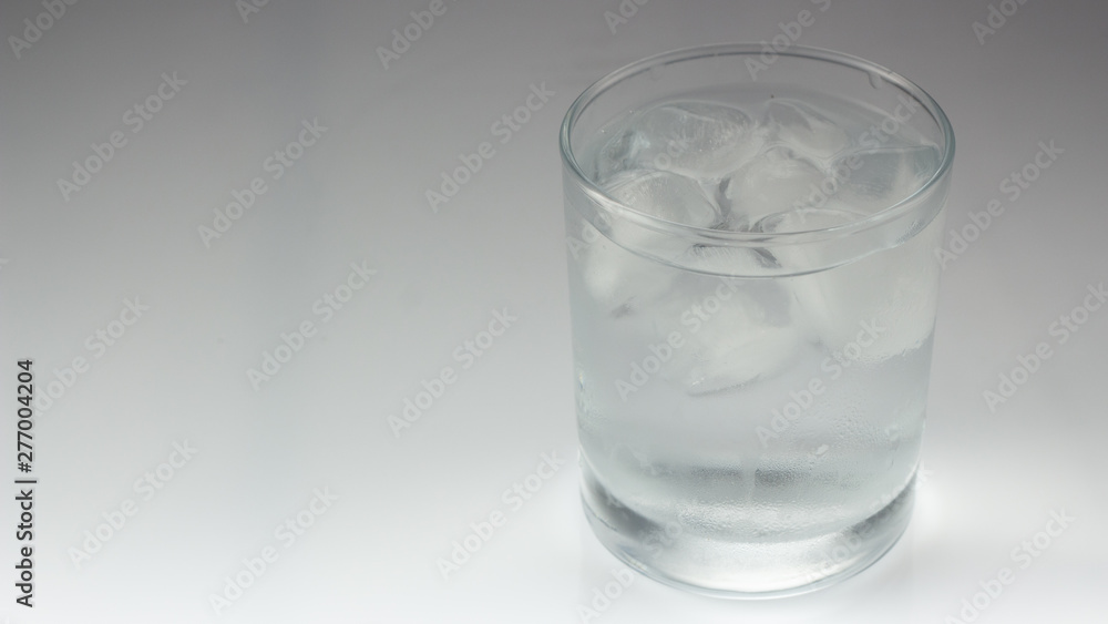 ice in a glass on a gray background ice in a glass on a gray background