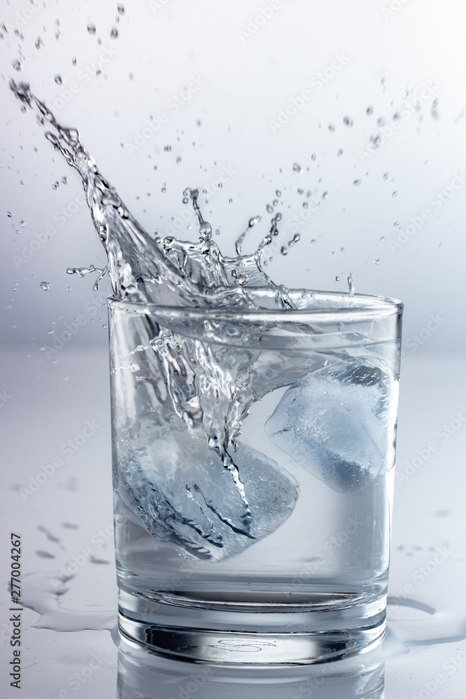 spray water in a glass on a gray background spray water in a glass on a gray background