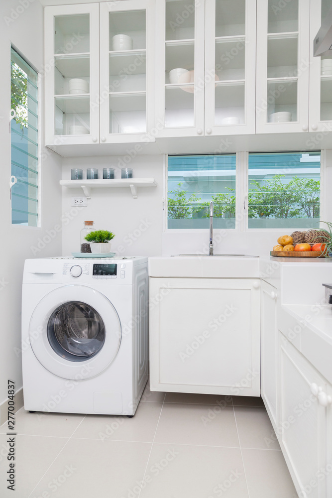 Interior of modern kitchen with washing machine. Laundry day Interior of modern kitchen with washing machine. Laundry day