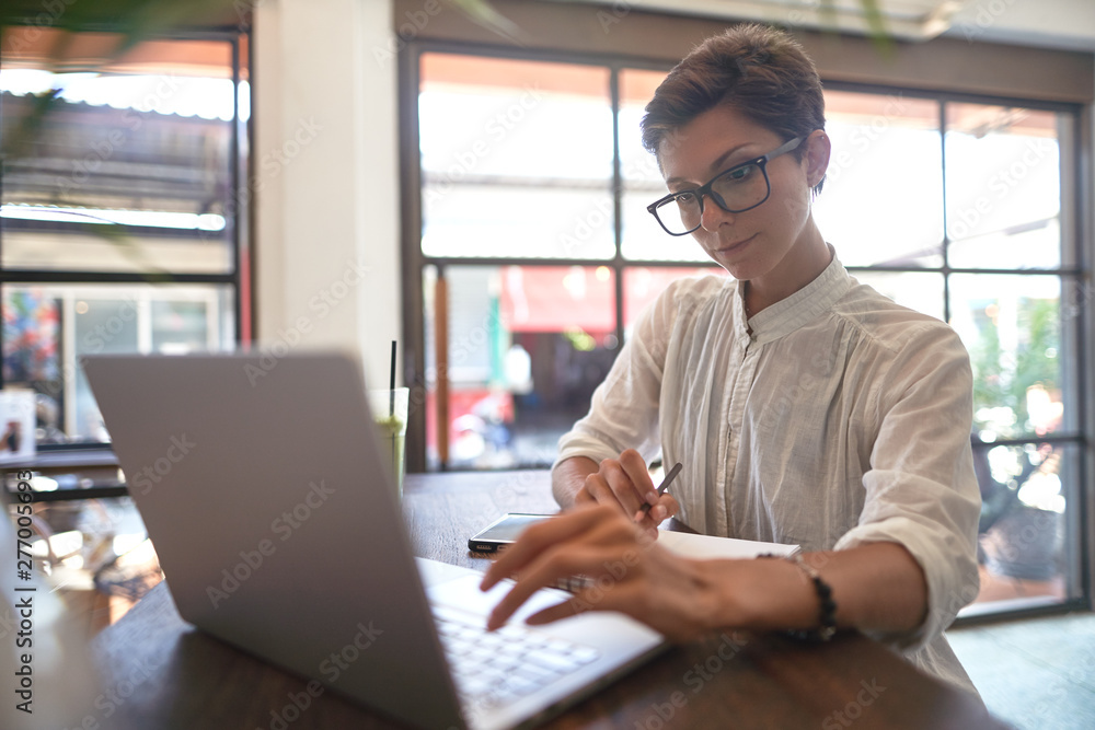 Girl working in a cafe. Freelance concept                   