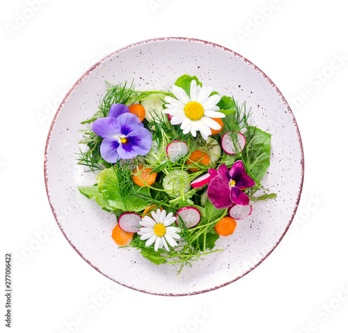 Quadro em tela Vegetable salad with edible flowers on white background