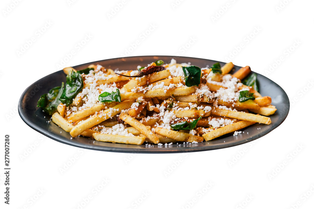 Isolated close-up French fries with fried basil, Thai chili and feta cheese with fork. Thai fusion food. Isolated close-up French fries with fried basil, Thai chili and feta cheese with fork. Thai fusion food.