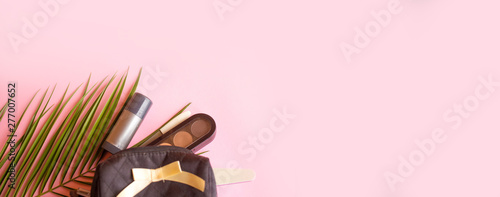 Palm leaf on a pink background and cosmetics women.