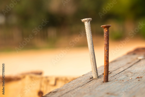 Rusty nails and new nails on the back, nailed on wood