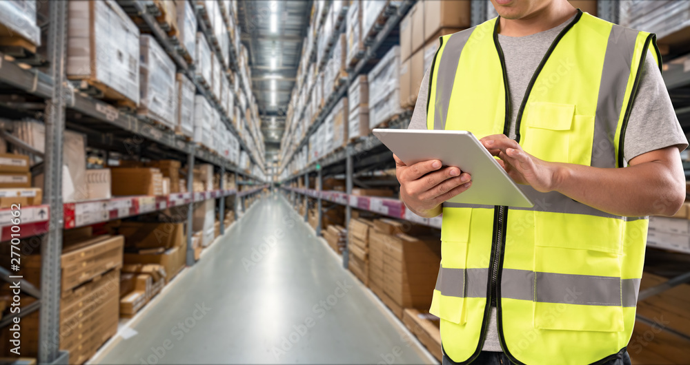 worker hand holding pad for check order pick time in smart factory warehouse worker hand holding pad for check order pick time in smart factory warehouse
