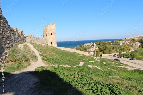 Ruins of the Genoese fortress in the city of Feodosia in the Crimea in the autumn under the open sky. Architecture, history, travel and tourism concept.