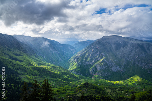 Montenegro, Spectacular tara river canyon nature landscape of green forested giant mountainside crossed by tara river in magical light after rain in durmitor national park near zabljak © Simon