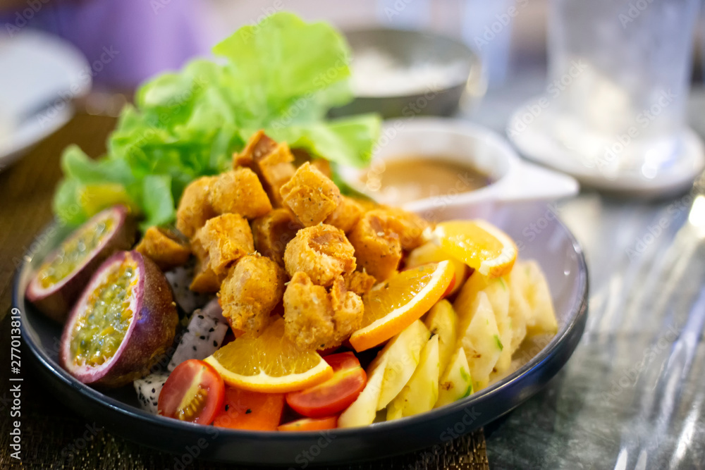 Vegetables and fruits salad with fried chicken meat, lettuce, orange, pineapple, dipping sauce. Healthy food lifestyle recipe. Vegetables and fruits salad with fried chicken meat, lettuce, orange, pineapple, dipping sauce. Healthy food lifestyle recipe.