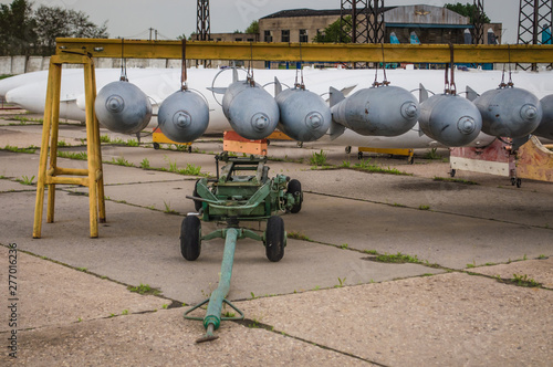 Aerial bombs fixed in line at military airfield.