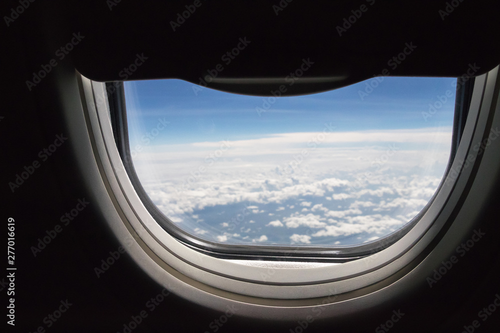 Window seat an open half-space in airplane with blue sky and clouds. Nice view seen from plane. Window seat an open half-space in airplane with blue sky and clouds. Nice view seen from plane.