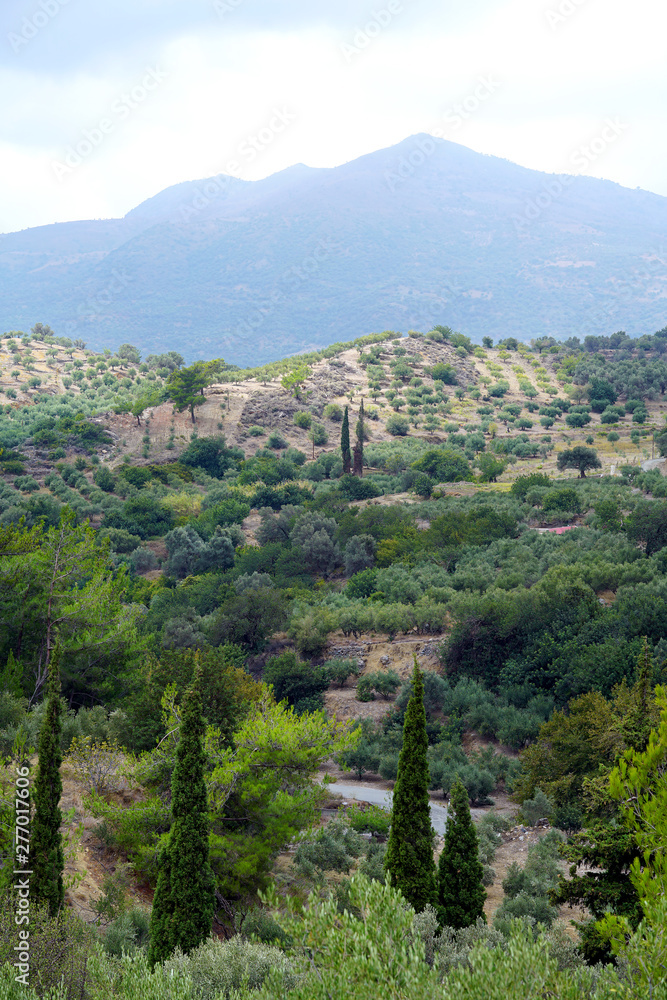 View of the countryside, of the hills with mountains in the background in Crete View of the countryside, of the hills with mountains in the background in Crete