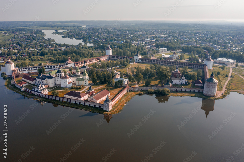 Scenic aerial view of old Cyril-Belozersky Monastery in Kirillov. Beautiful sunny summer look of ancient male orthodox monastery with reflection in lake in Vologodskaya oblast in Russian Federation