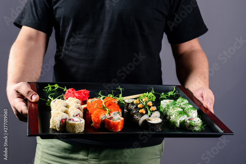 chef with a sushi tray, set rolls sushi japanese asian traditional food