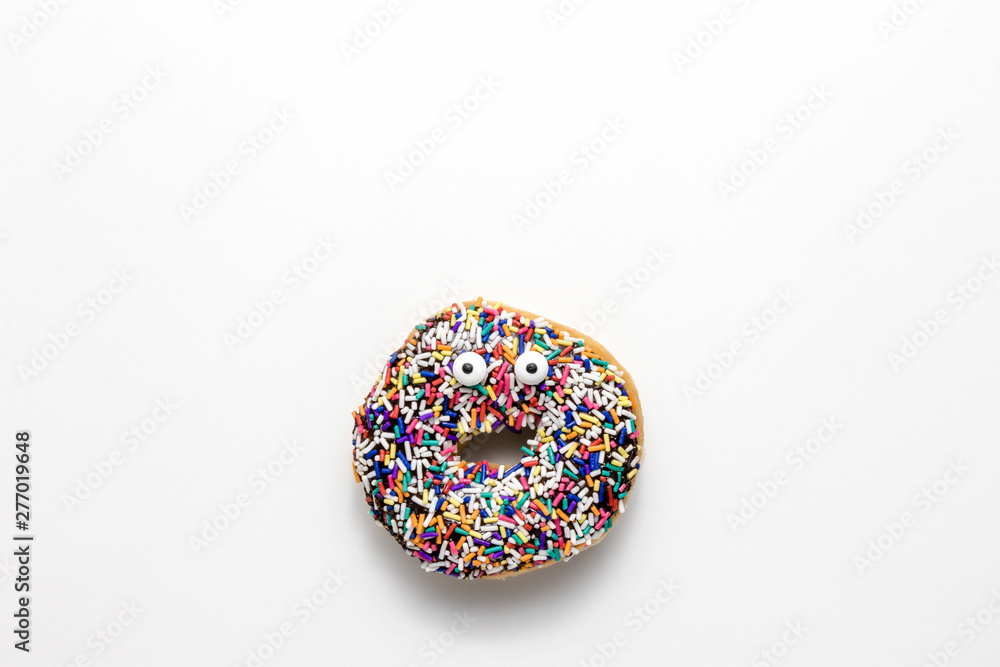 Funny shock face chocolate donut with sprinkles on a white background, creative minimal food concept with copy space Funny shock face chocolate donut with sprinkles on a white background, creative minimal food concept with copy space