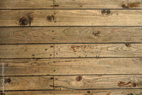 Top down view - old wooden floor texture, tiles secured with nails.