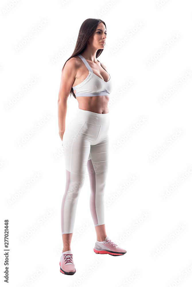 Athletic fit young attractive woman in sportswear stretching arms muscles with hands behind back. Full body isolated on white background. Athletic fit young attractive woman in sportswear stretching arms muscles with hands behind back. Full body isolated on white background.