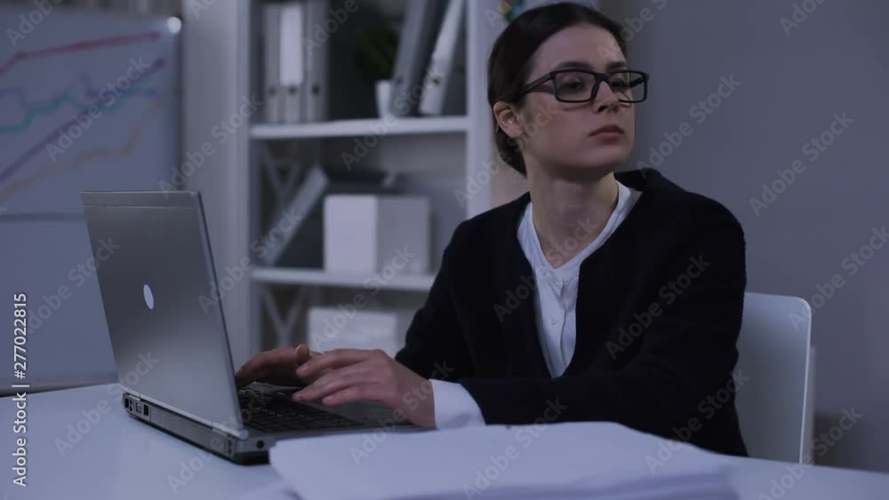 Female secretary feeling desperate, looking at pile of documents, bookkeeping Female secretary feeling desperate, looking at pile of documents, bookkeeping