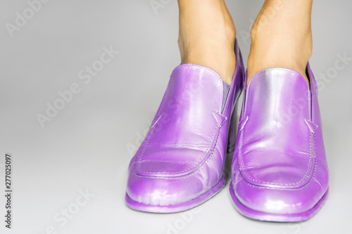 Woman wearing purple shoes , studio shot 