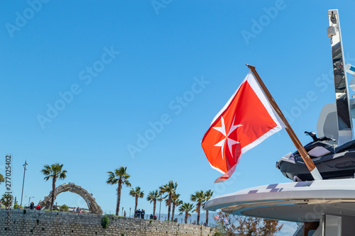 Принти на полотні Maltese old flag on pole on ferry's stern