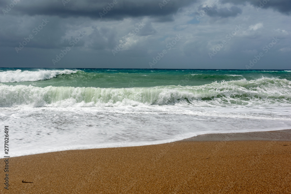 Waves On sand beach of the Aegean Sea in Rhodes.