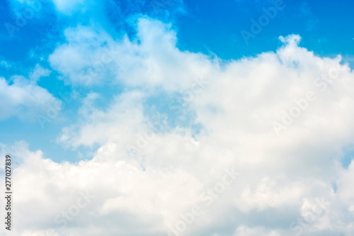 Beautiful natural blue sky background with clouds in sunny day. © Inna